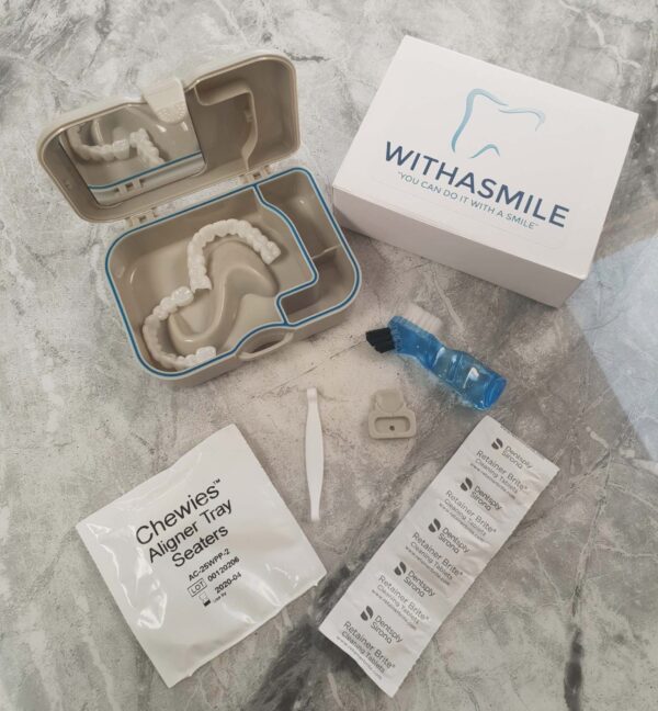 Overhead view of a Withasmile dental veneers kit, laid out on a table, showing the veneers and all accessories